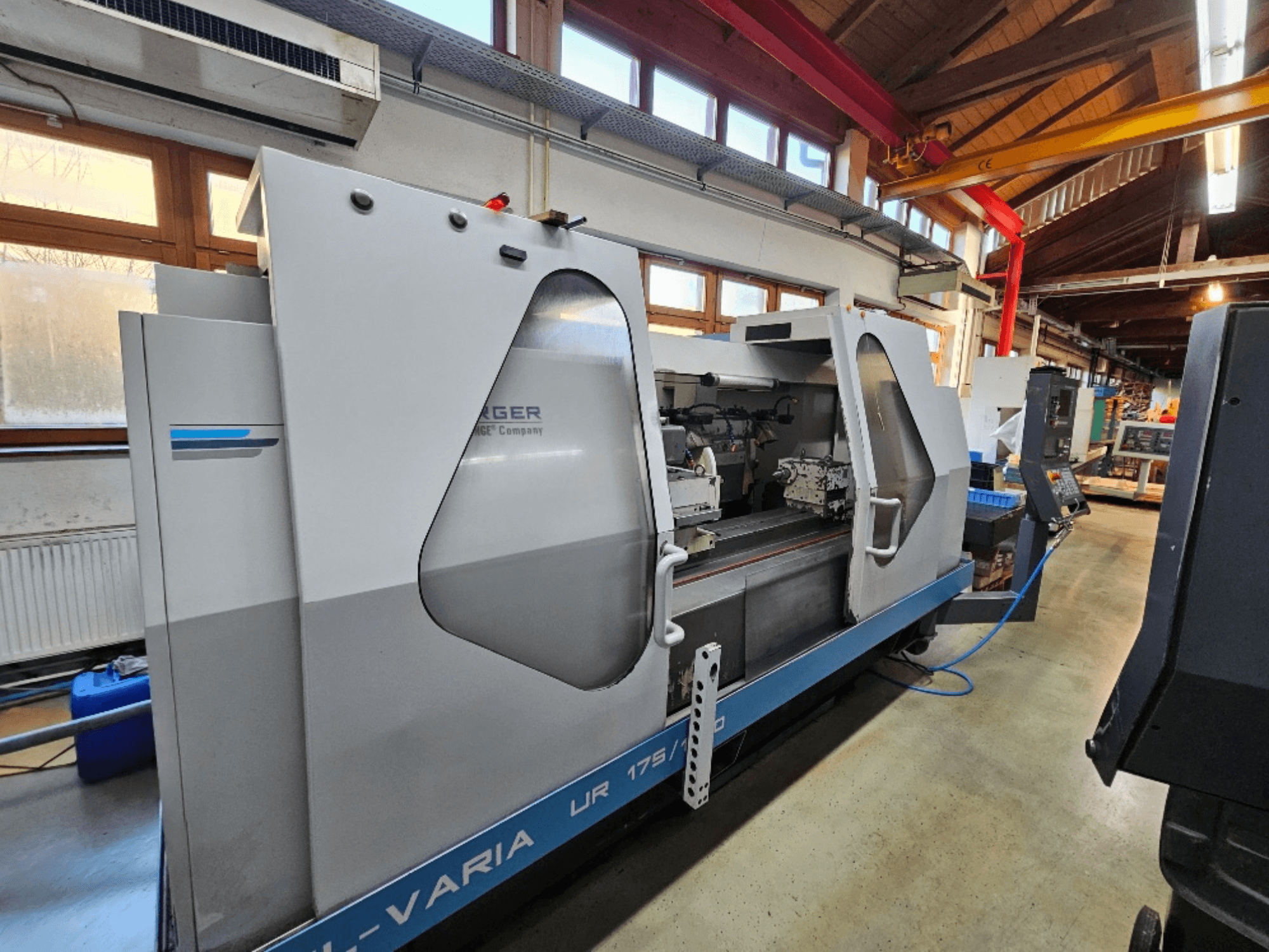 Maszyna CNC firmy Burg, model UR 175/300, widok z boku. Charakteryzuje się elegancką konstrukcją z widocznymi elementami sterującymi i obszarem roboczym.