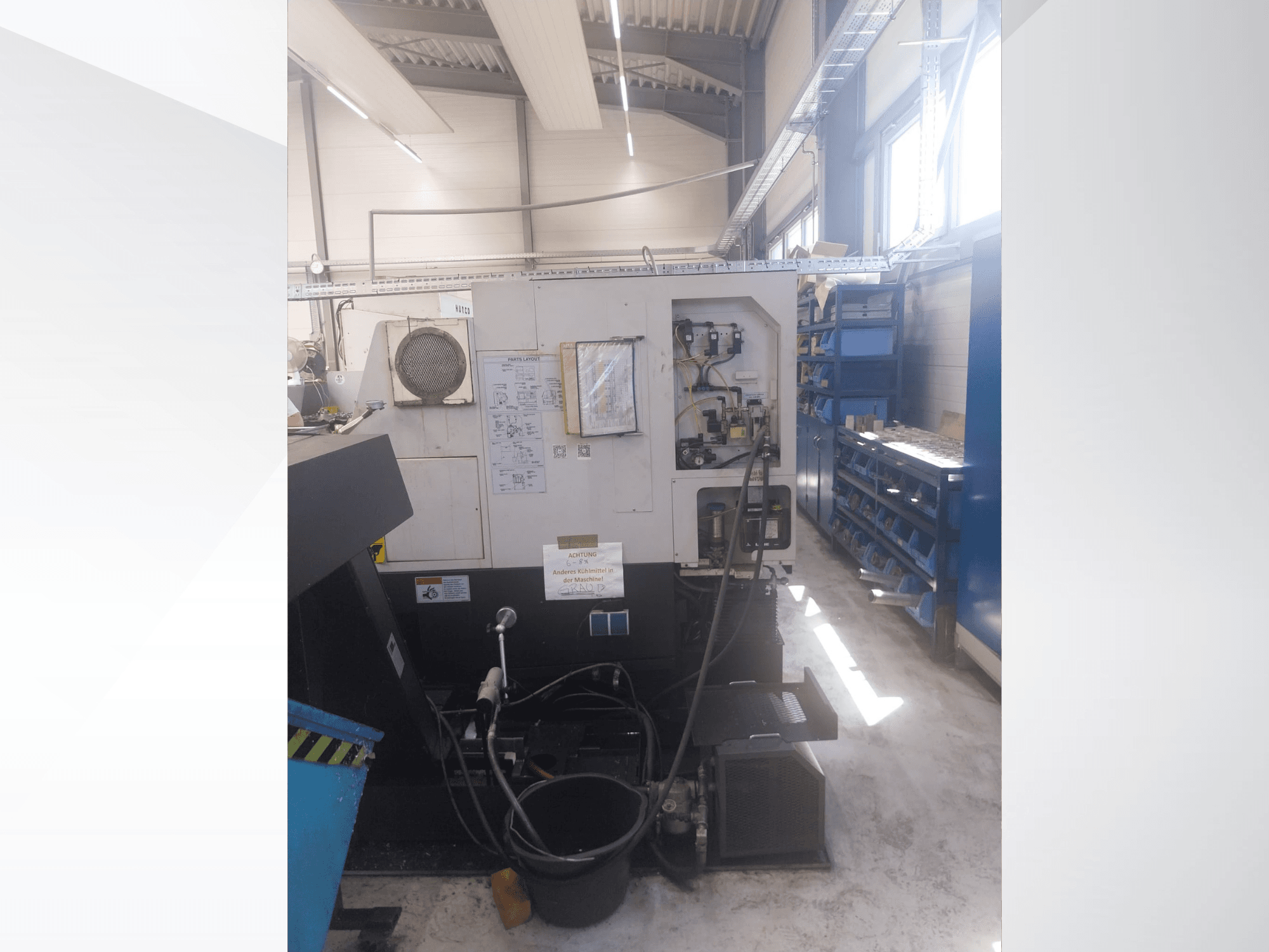Mazak QUICK TURN NEXUS 200 MS – widok z boku przedstawiający panel sterowania, węże i obszar narzędzi w warunkach warsztatowych.