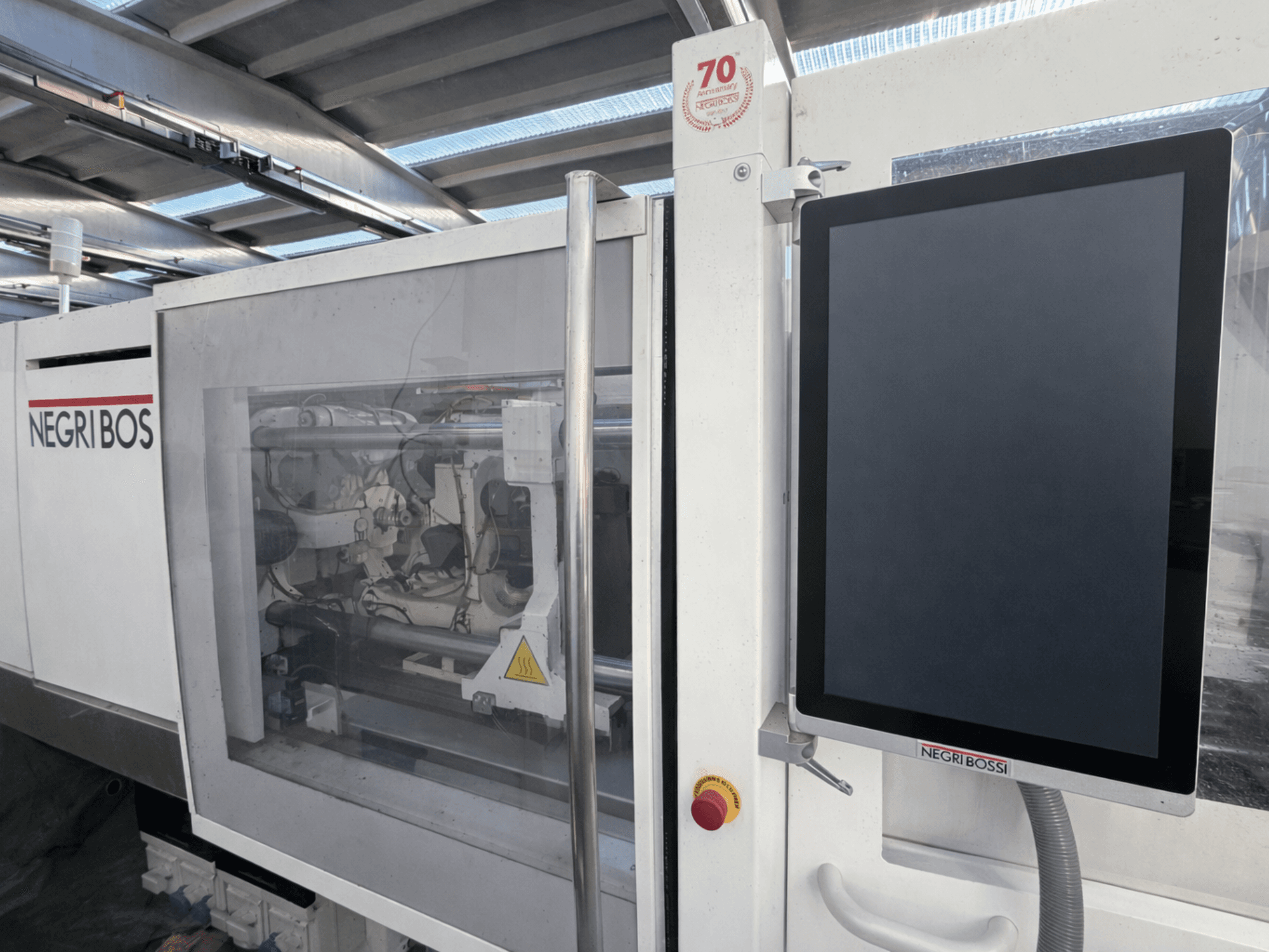 Wtryskarka elektryczna Negri Bossi ELE 80, widok z przodu z ekranem sterowania i widocznymi elementami wewnętrznymi.