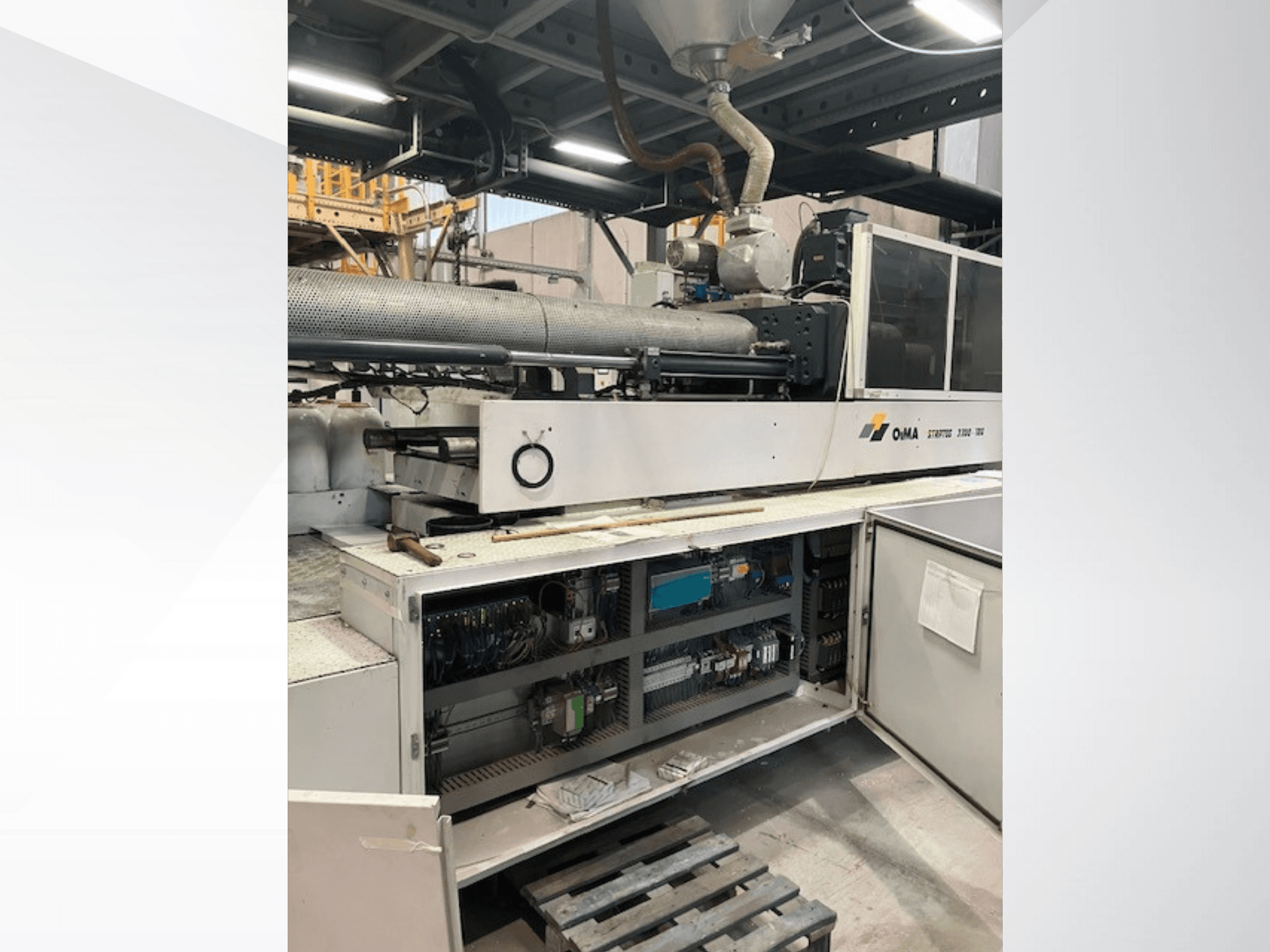 Widok z przodu ekstrudera OMA 3500, przedstawiający części operacyjne, panel sterowania i szczegóły okablowania. Ciężka maszyna w środowisku przemysłowym.