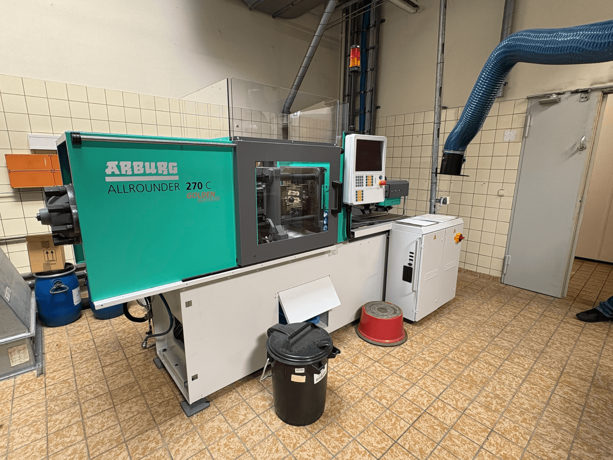 Hydrauliczna wtryskarka Arburg ALLROUNDER 270 C widziana z boku, wraz z panelem sterowania i podłączonymi urządzeniami.