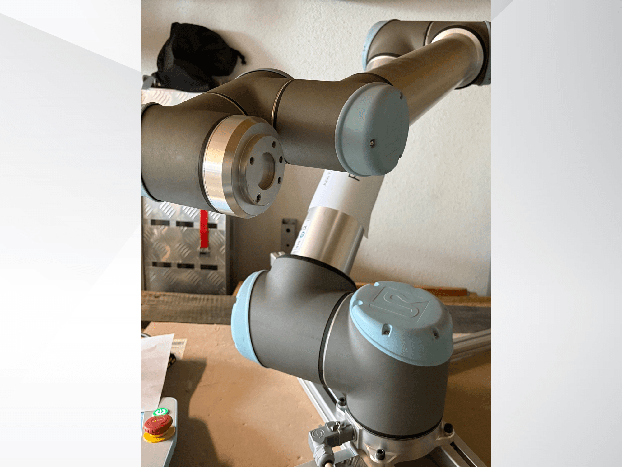 Zbliżenie z boku ramienia robota Universal Robots UR10 z wyróżnionymi przegubami i szaro-niebieskimi elementami konstrukcyjnymi.