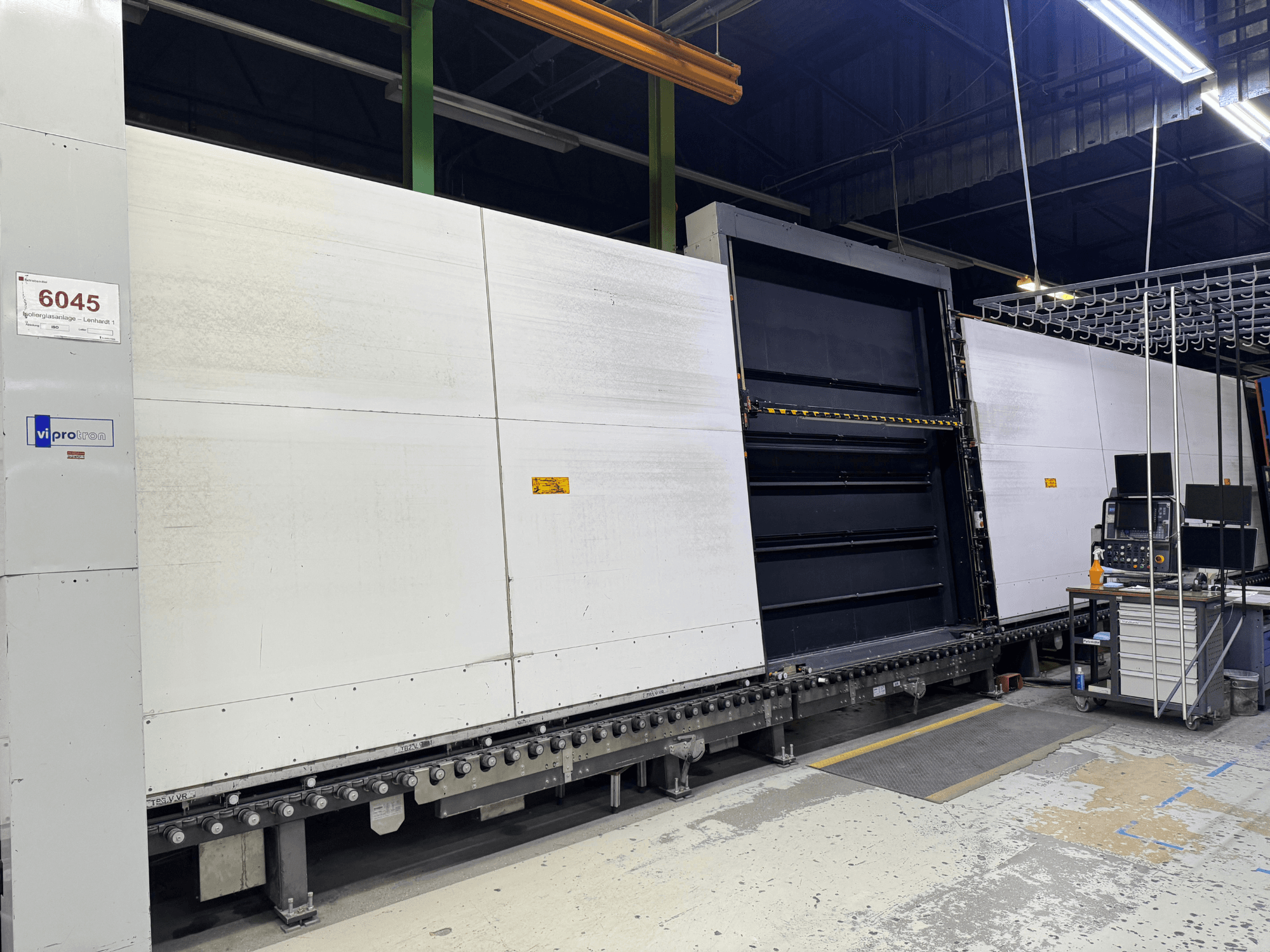 Widok z przodu maszyny do formowania Vipro z otwartym panelem, prezentującym sprzęt operacyjny i obszar roboczy obok niego. Model 6045.