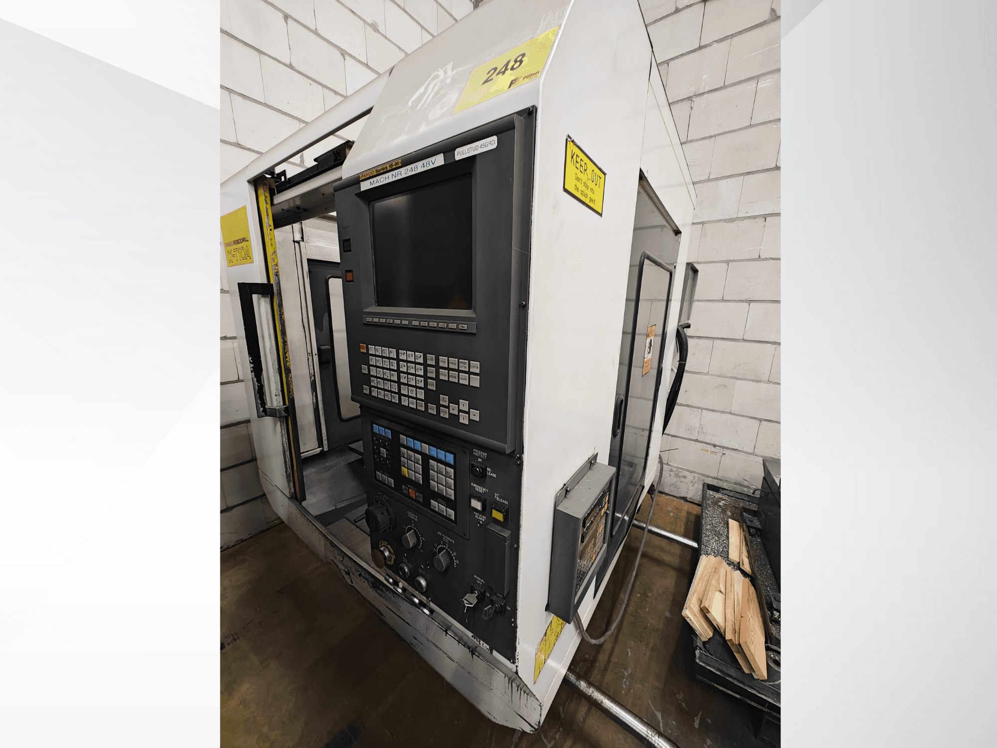 Model maszyny CNC Nr 248, widok z przodu, z panelem sterowania z przyciskami i wyświetlaczem, z elementami drewnianymi na półce obok.